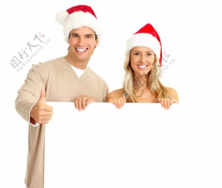 带圣诞帽手拿空白广告牌的美女帅哥图片