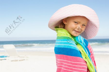 沙滩上裹着浴巾的小女孩图片