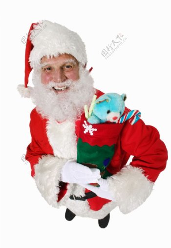 抱着玩具熊慈祥的圣诞老人图片
