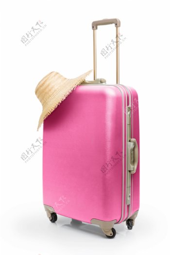 粉色行李箱与遮阳帽图片