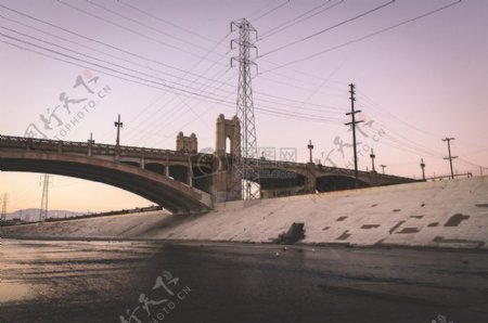 灰色的水泥桥附近输电塔